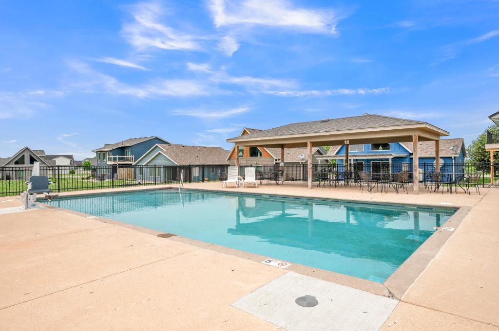 a swimming pool in front of a house at Poolside Retreat at Bridges Bay in Arnolds Park