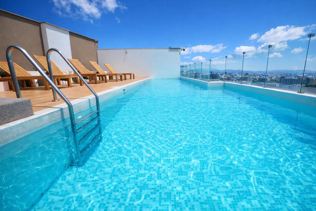 a swimming pool on the roof of a building at Miraflores Nest Upper Pardo in Lima