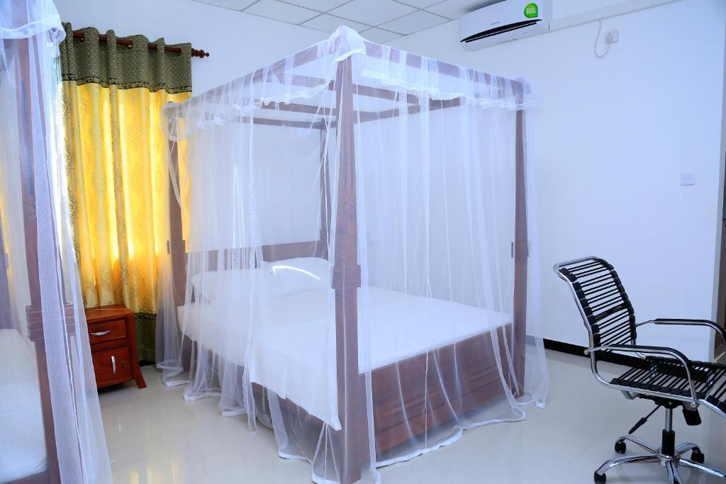 Postel nebo postele na pokoji v ubytování V Cabanas & Yala Safari Place