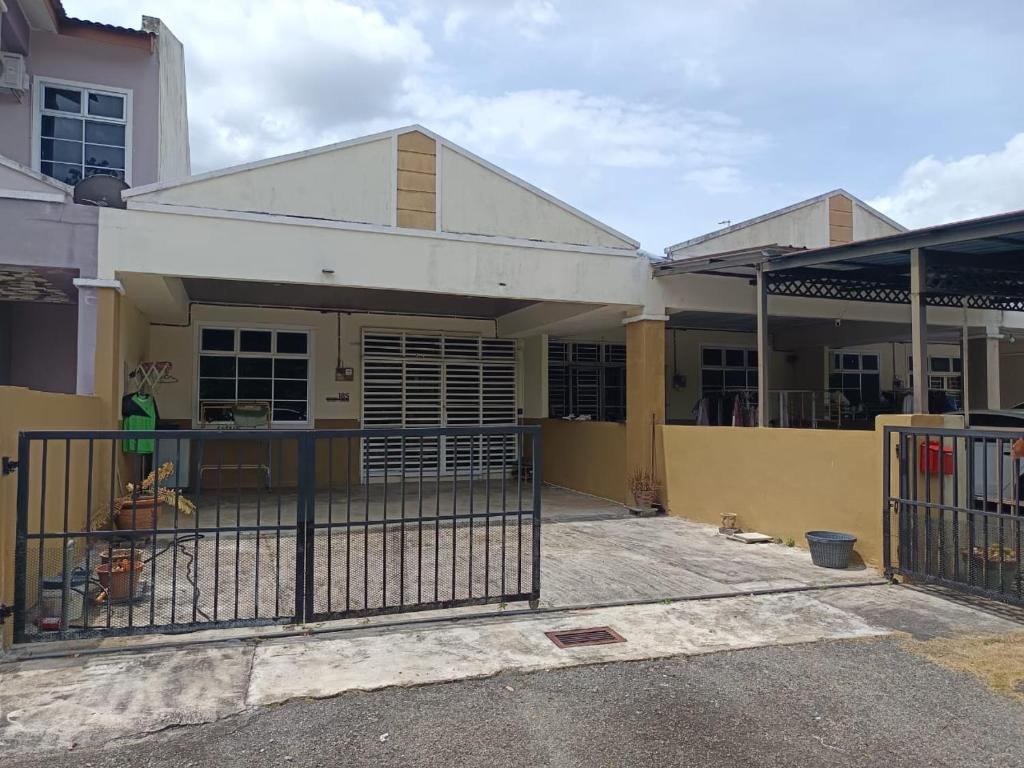 a house under construction with a gate in front of it at Aisyhome in Jitra