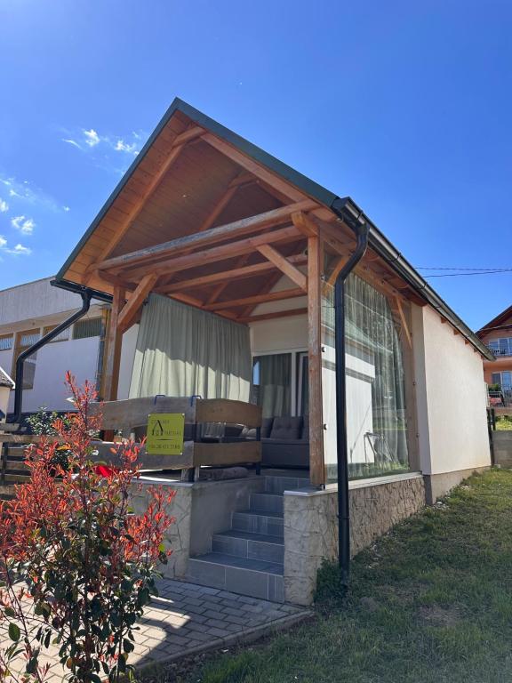 a house with a porch with a sign on it at ZitaLaka in Igal