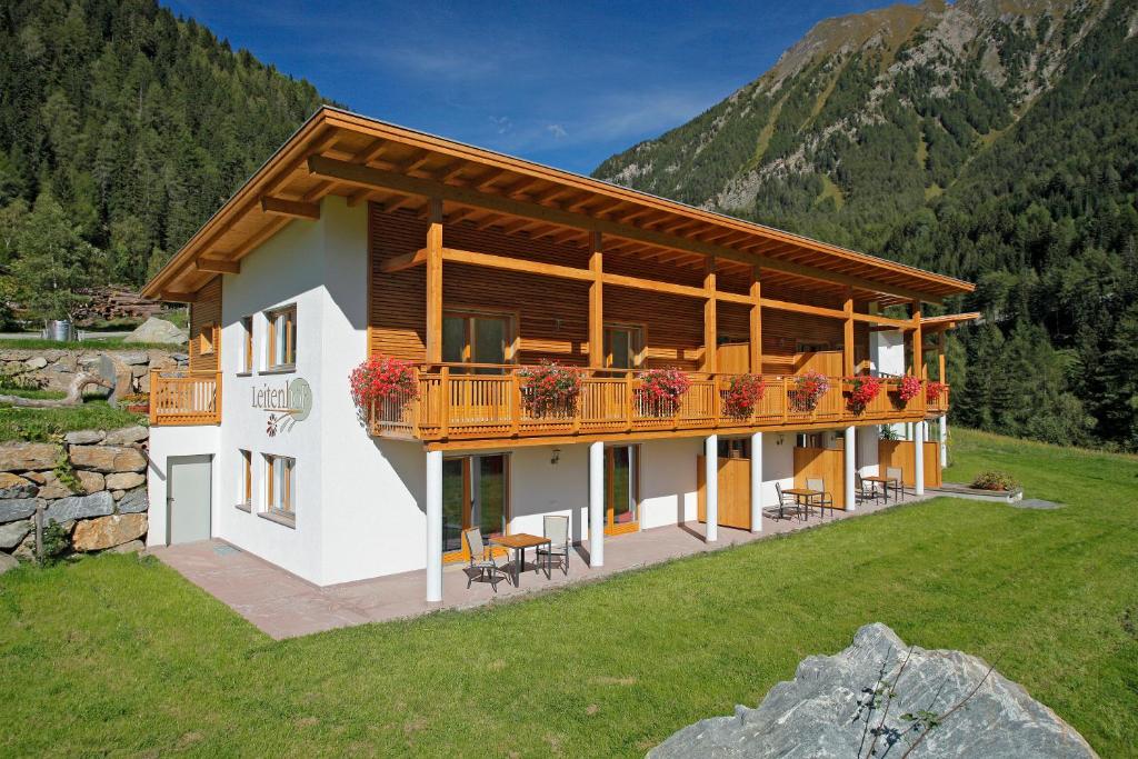 una casa con un balcón con flores. en Leitenhof en Val di Vizze