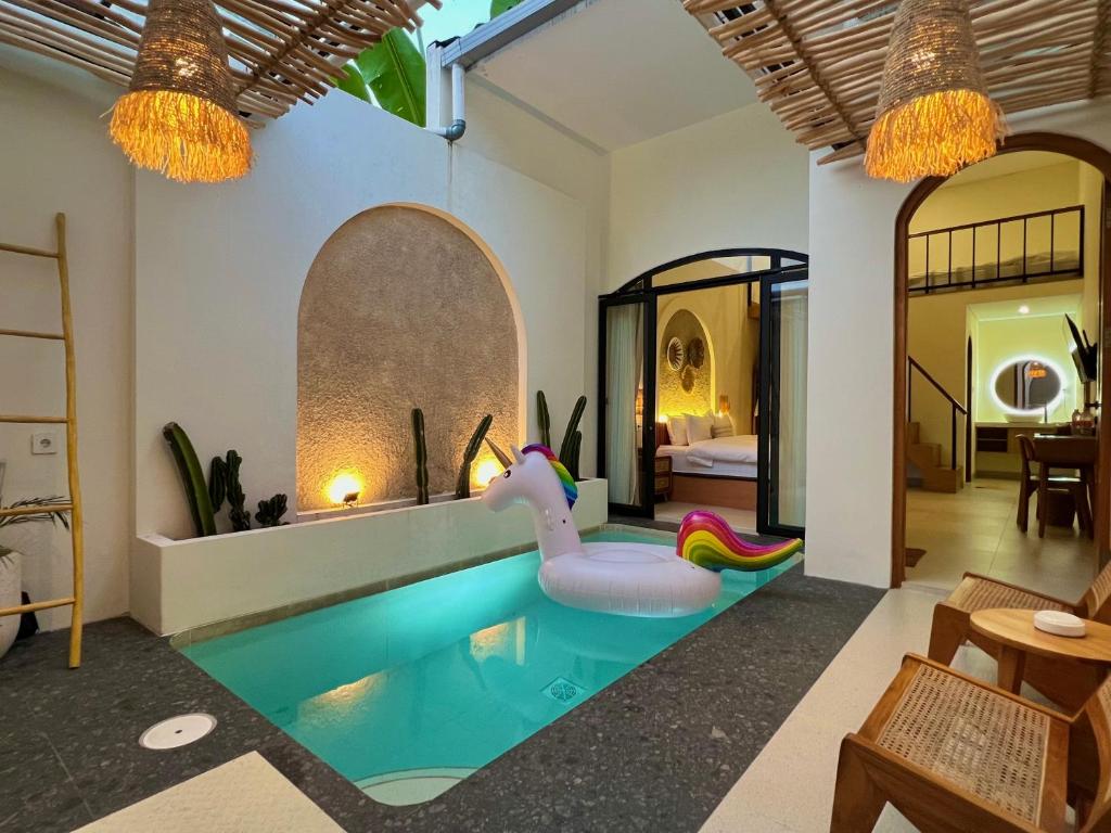 an indoor pool with an inflatable elephant in a house at Numar Villas Yogyakarta in Seturan