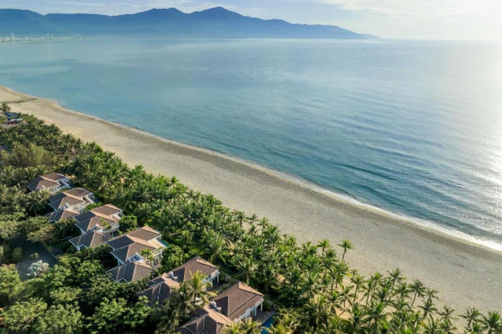 an aerial view of a beach with houses at Luxury Private Pool Villas at Village Danang Resort in Danang