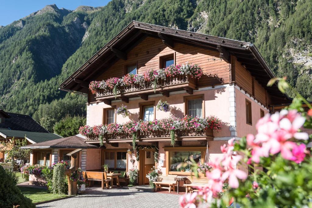 a house with flower boxes on the side of it at Landhaus Lackner in Heiligenblut