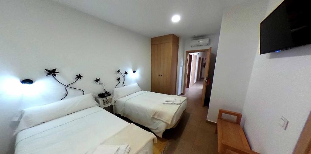 Postel nebo postele na pokoji v ubytování Hostal Aquaforum