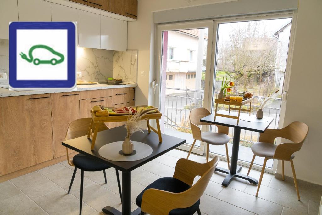 a kitchen with a table and chairs and a tv at Double Room with Breakfast Free Parking and EV ready in Postojna