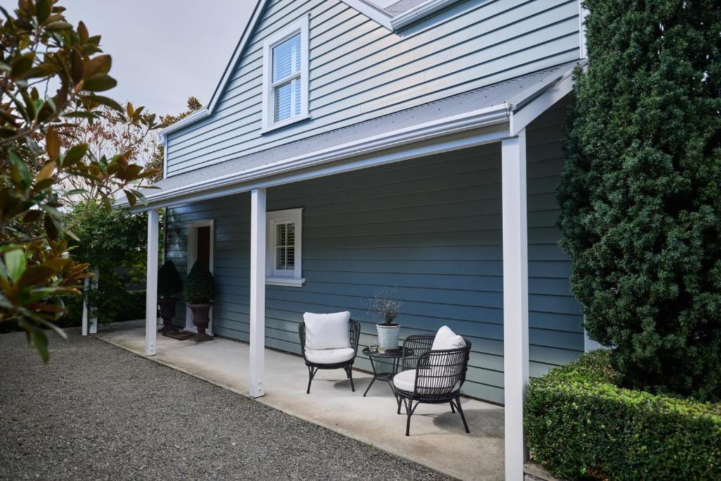 a patio with two chairs and a table in front of a house at Briarwood in Greytown