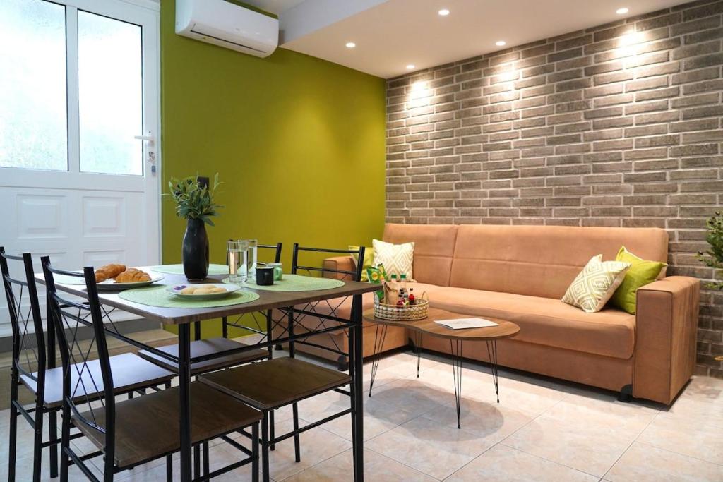 a living room with a couch and a table at Olive Groove Chios in Chios
