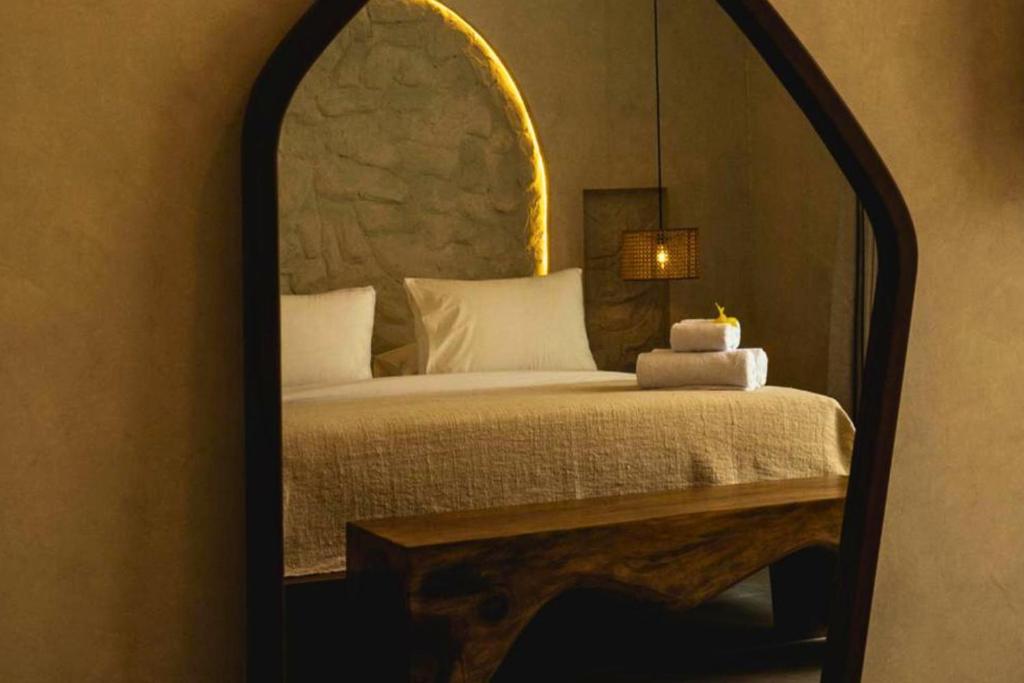 a bedroom with a bed with a large mirror at Bilha 1 BR Deluxe Suite Room in Kuta Lombok