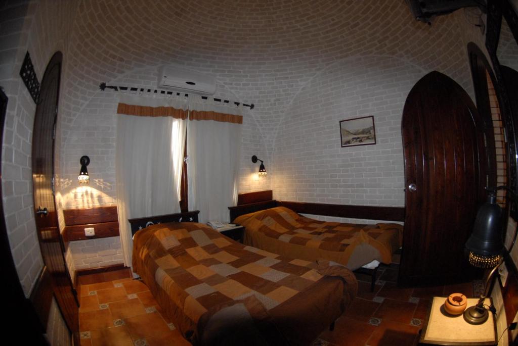 A bed or beds in a room at Nesima Resort
