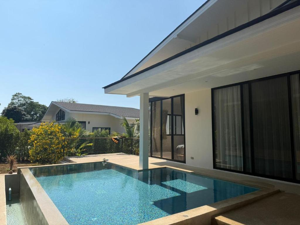 a swimming pool in the backyard of a house at Phangan Sky Villa in Ban Madua Wan