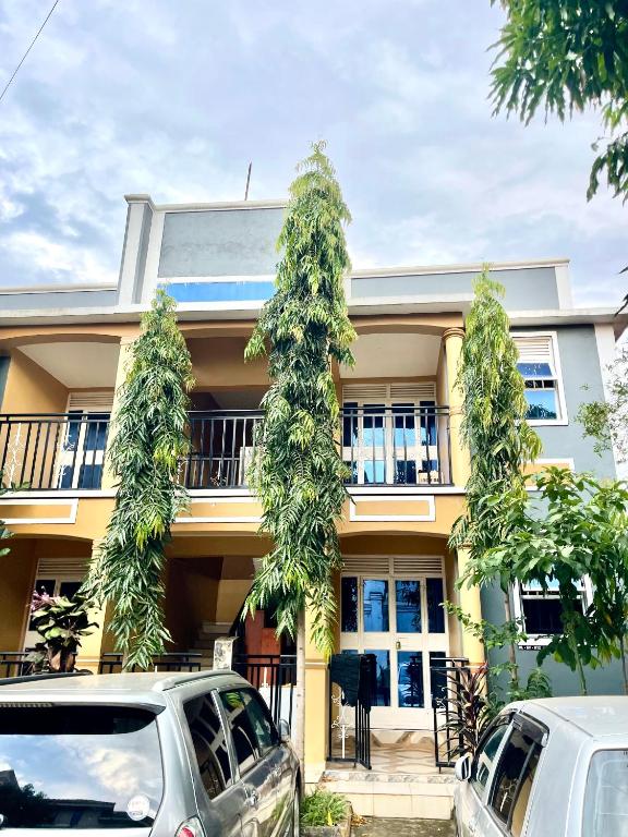 a house with cars parked in front of it at Serenity homes Uganda in Mbale
