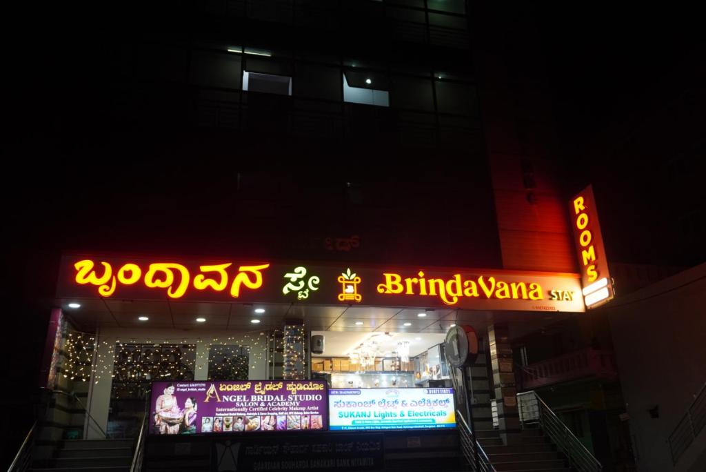 a building with neon signs on it at night at Brindavana Stay in Bangalore