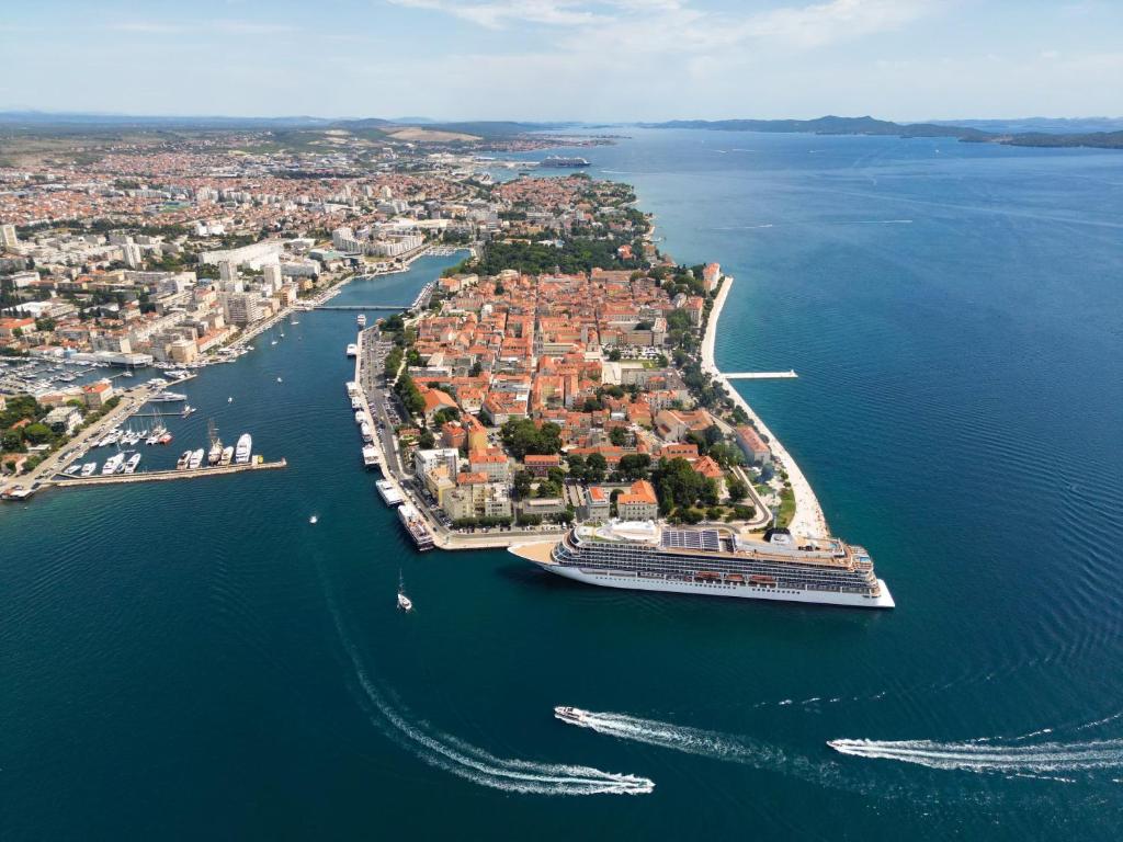 an island with a cruise ship in the water at Apartment Poluotok in Zadar