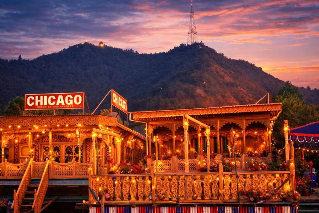 a chinese restaurant with a mountain in the background at Chicago Group of Houseboats in Srinagar