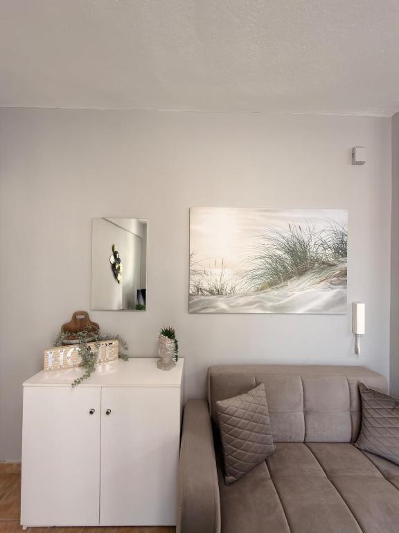 a living room with a couch and a white cabinet at Keremidis Apartment in Flogita