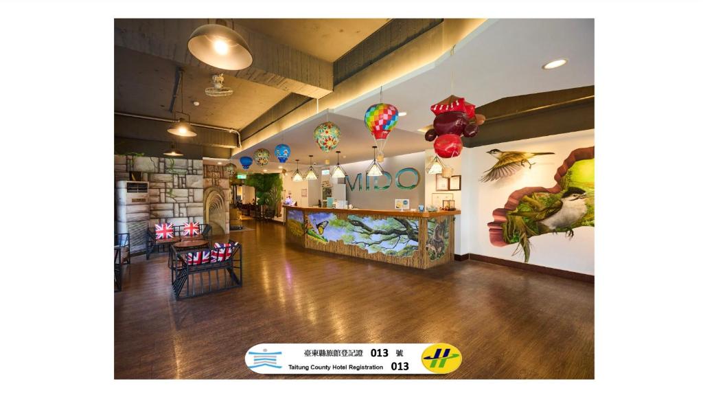 a lobby of a restaurant with a bar and balloons at Traveller Inn - Mido Hotel in Taitung City