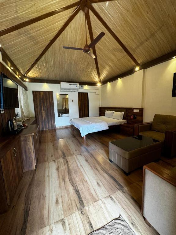 a large room with a bed and a couch at Ashaya Agro Farm in Thane