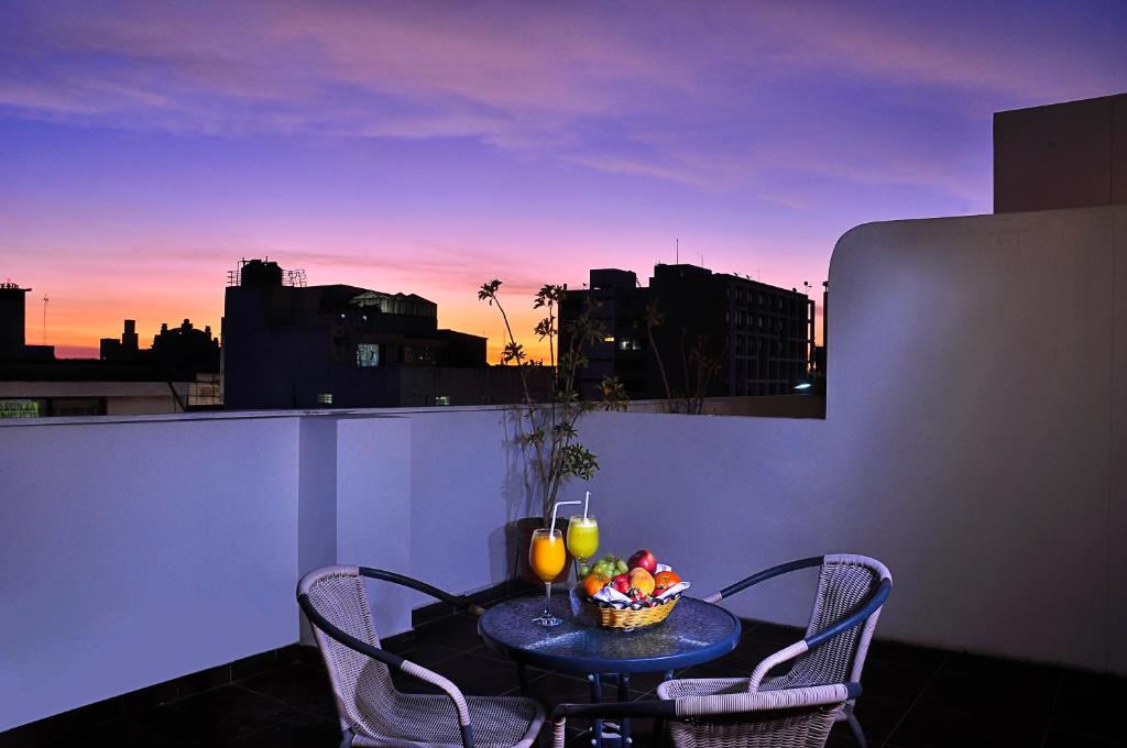 a table with a bowl of fruit on a balcony at Casona Plaza Hotel Arequipa in Arequipa