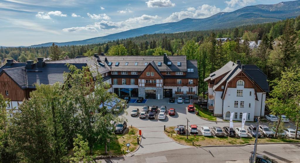 an aerial view of a town with cars parked in a parking lot at Hotel Bergo Resort & SPA in Szklarska Poręba