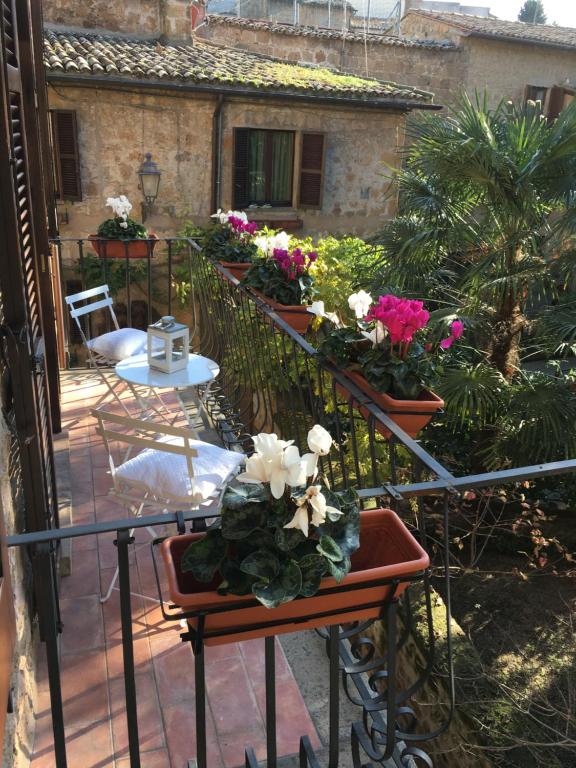 a balcony with a bunch of flowers on it at B&B Michelangeli - Private parking in Orvieto