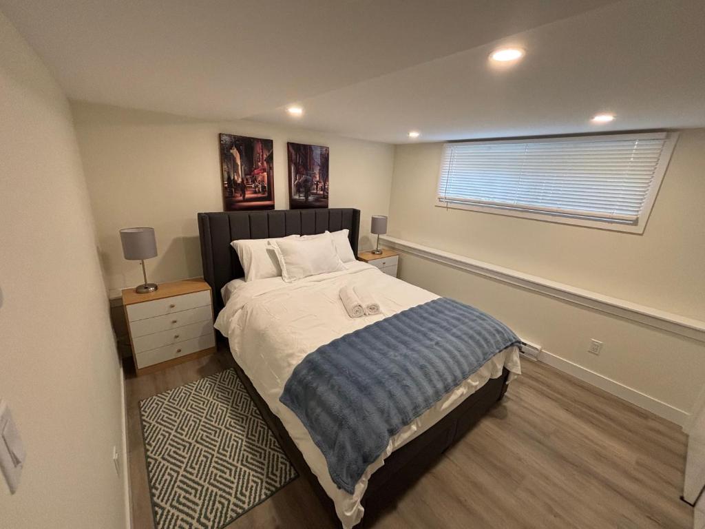 a bedroom with a large bed and a window at Private Guest Suite In Colwood in Colwood