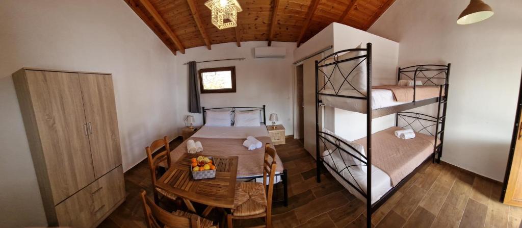 a room with a table and two bunk beds at Ada in Kamáres