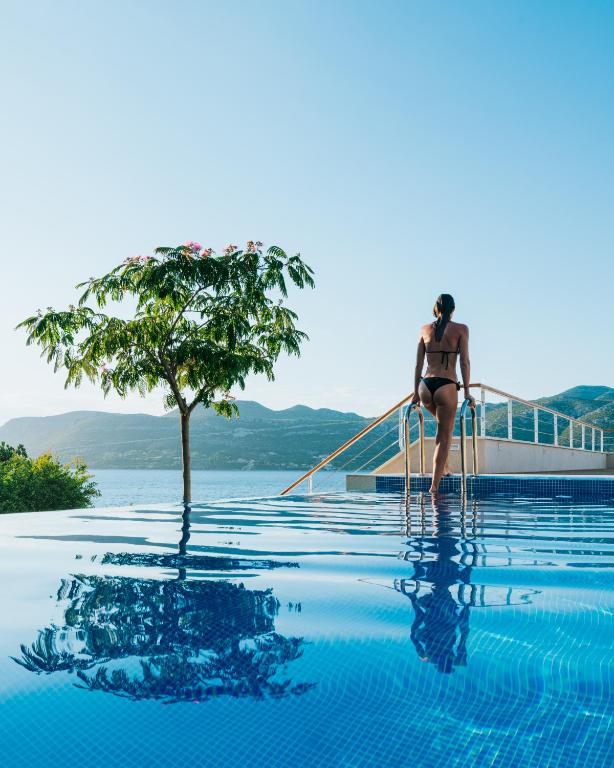 a woman in a bikini is standing in a swimming pool at Villa Soul Sisters in Korčula