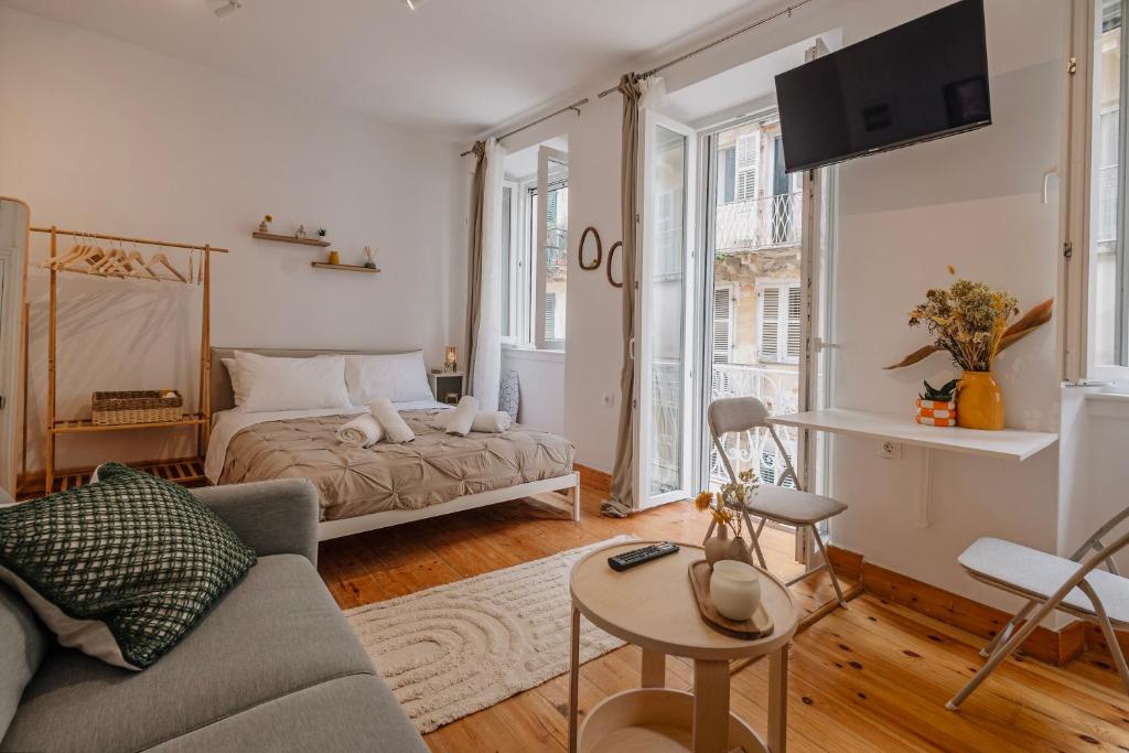a living room with a bed and a couch at Tonella Studio in Corfu