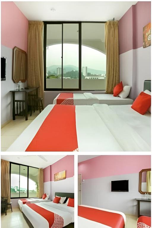 two beds in a room with pink and white at Feringghi Stay Iinn in Batu Ferringhi