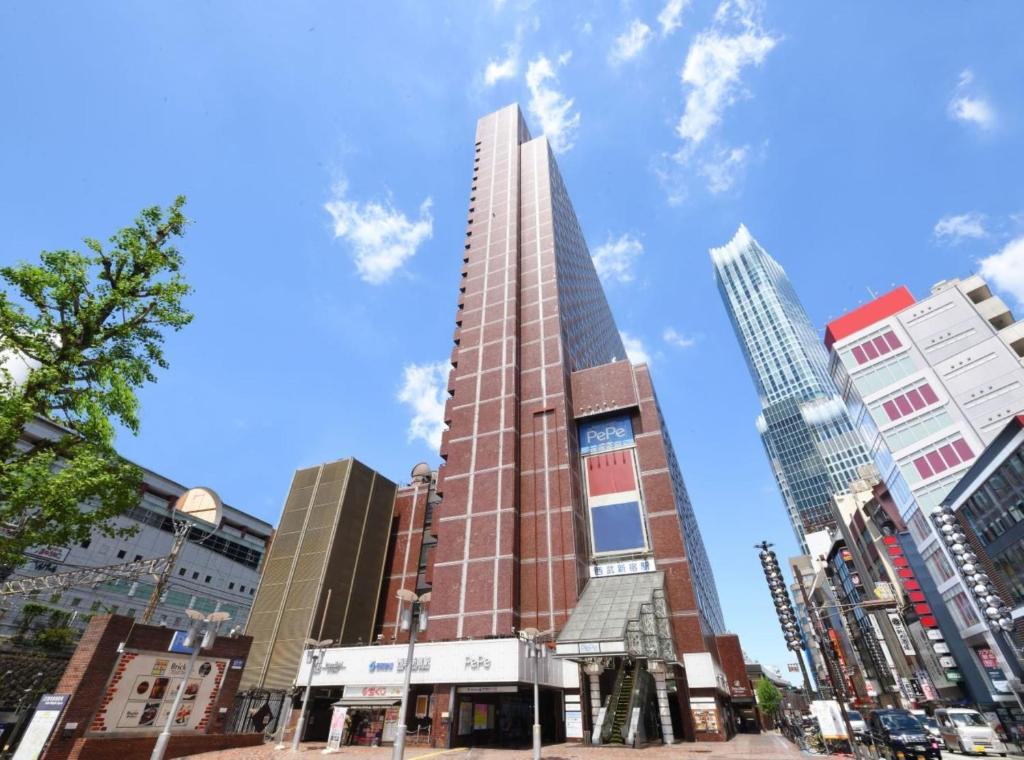 a tall building in the middle of a city at Shinjuku Prince Hotel in Tokyo