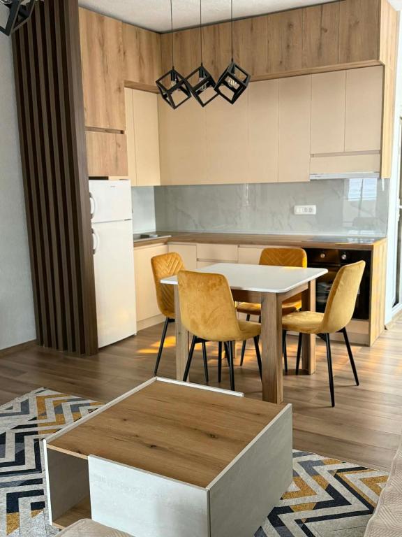 a kitchen and dining room with a table and chairs at Central Lux Stay Prilep in Prilep