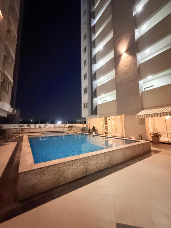 a swimming pool in the middle of a building at night at The Sakshi suite - Luxury Saty with Premium Comfort in Jaipur