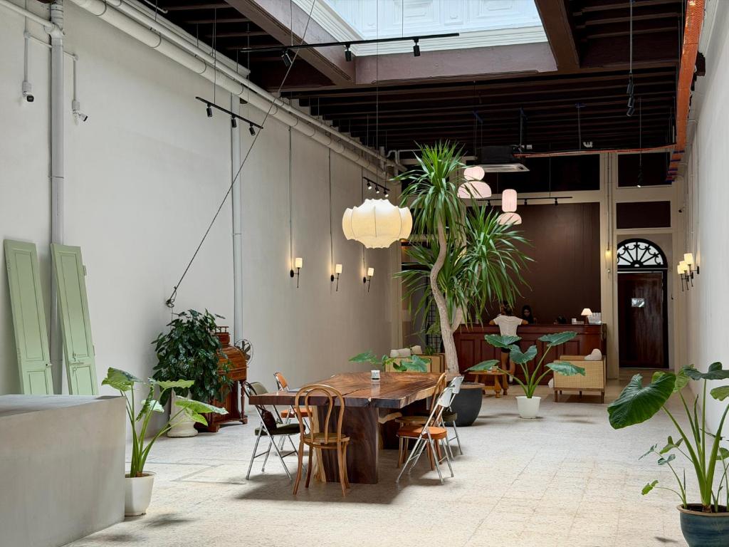 a dining room with a table and potted plants at Love Linn in George Town