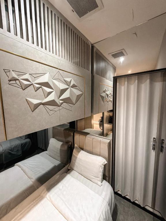 a bedroom with two beds and a wall with paper airplanes at Transit Room in Riyadh