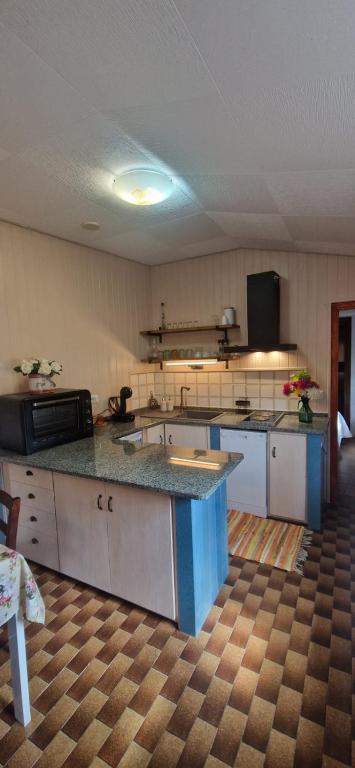 a large kitchen with a large island in a room at Tertium Home in Telti