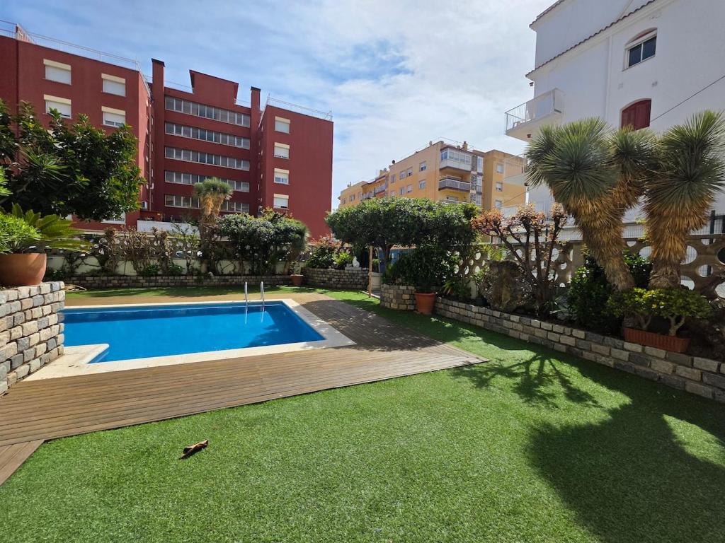 a swimming pool in the middle of a city at Apartamento en Mar Blau Calella in Calella