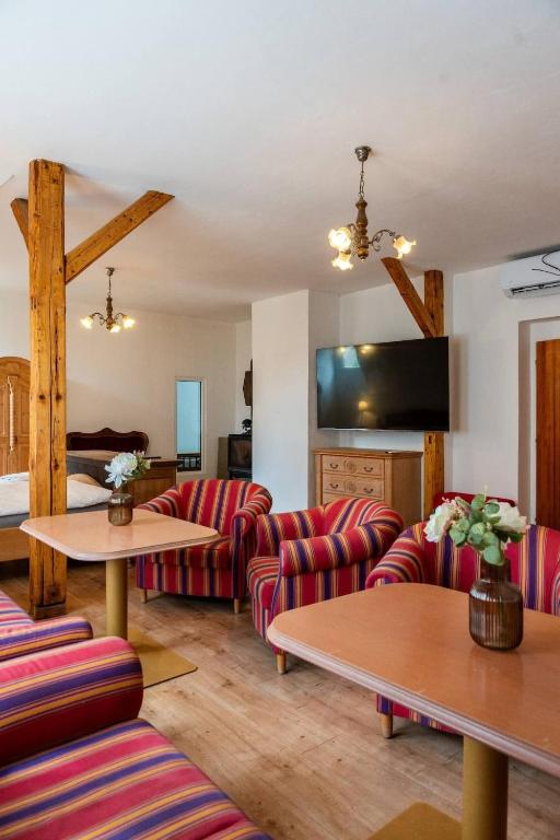 a living room with couches and tables at Tavba apartment in Česká Lípa