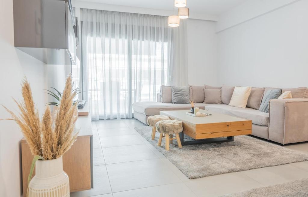 a living room with a couch and a coffee table at White Haven in Korinthos