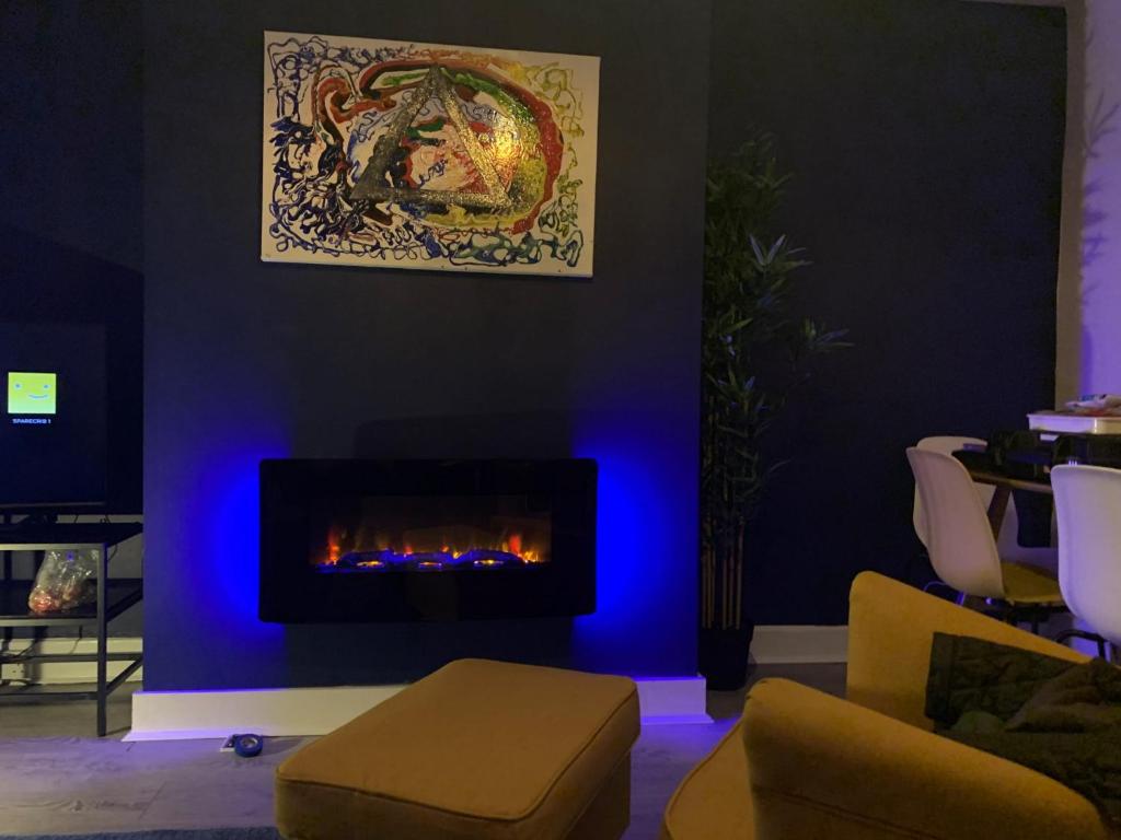 a living room with a fireplace with blue lighting at Consett Gorgeous Two Bedroom Apartment in Consett