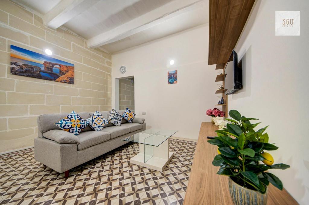 a living room with a couch and a glass table at Private Room in Hamrun HMR006 in Hamrun