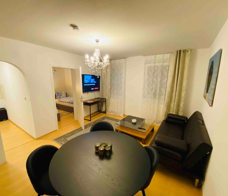 a living room with a table and a couch at Weimar Cityappartement in Weimar