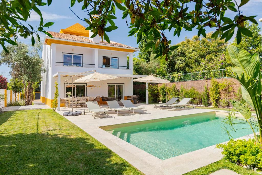 a villa with a swimming pool and a house at Villa Vintage, By Home Match in Azeitao