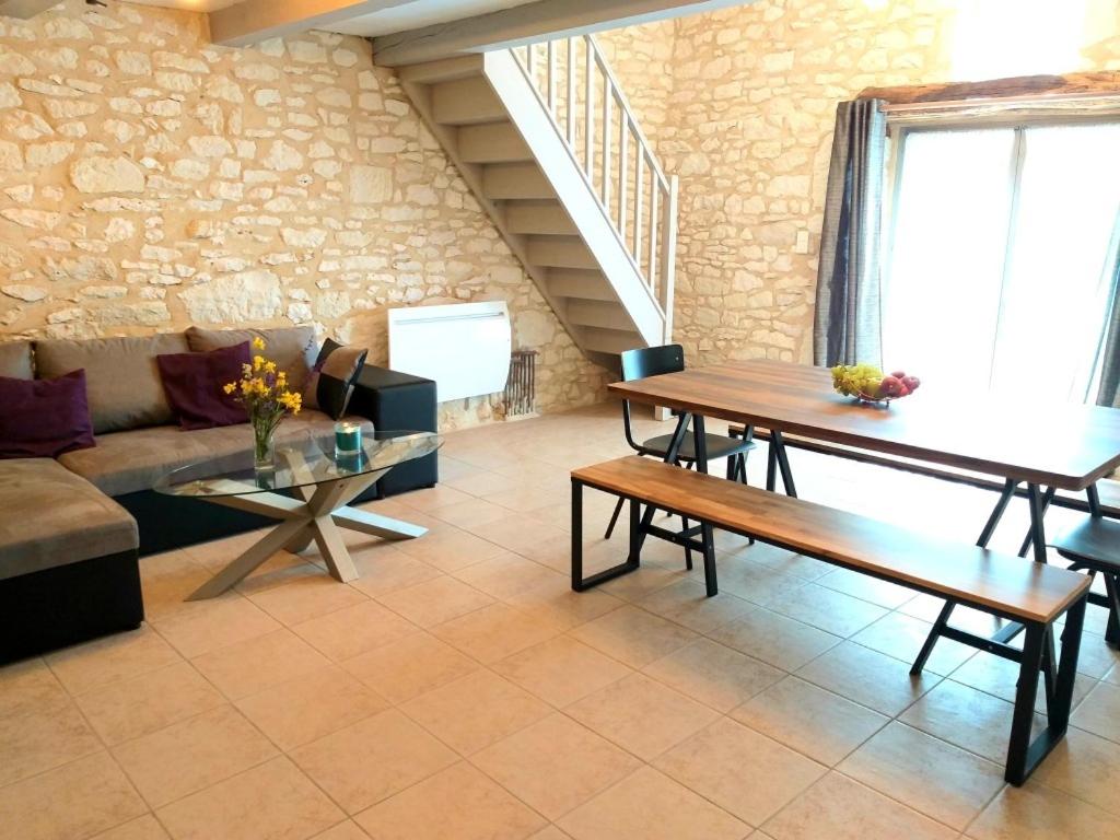 a living room with a table and a couch at La Borieta in Labastide-de-Penne