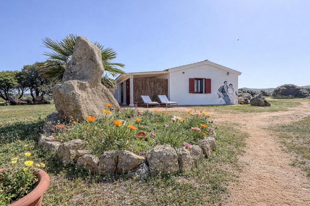 a house with a rock garden in front of it at Tegghja Country Suites in Rena Majore