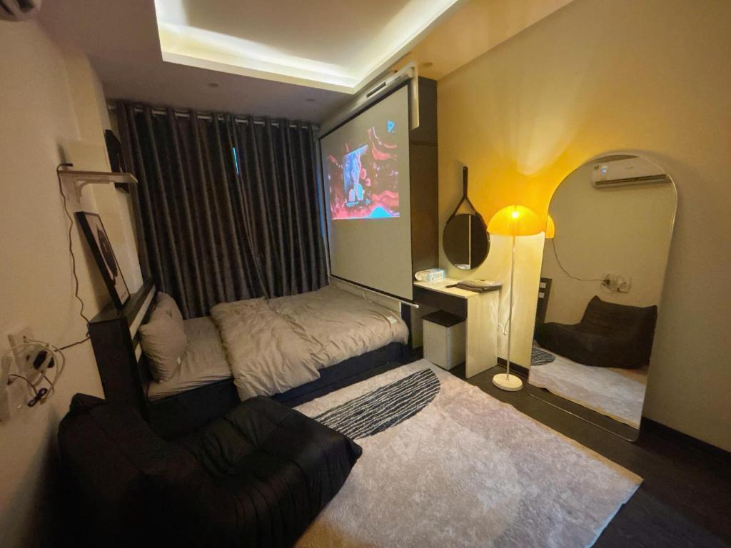 a bedroom with a bed and a desk and a lamp at Amoureux Cầu Diễn in Tây Tựu