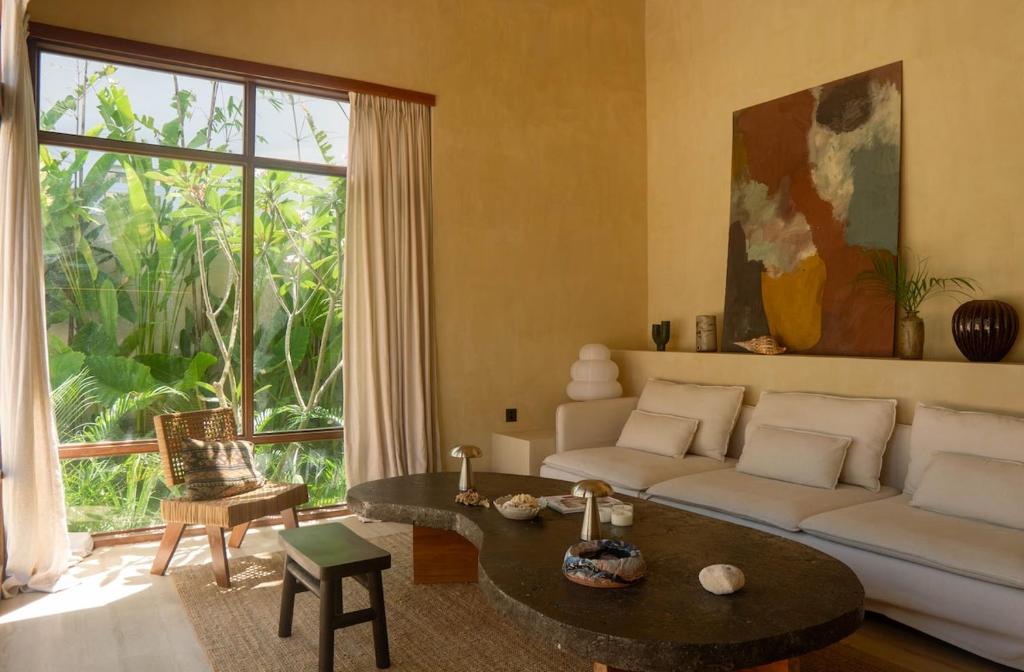a living room with a couch and a table at Casa Kalma in General Luna