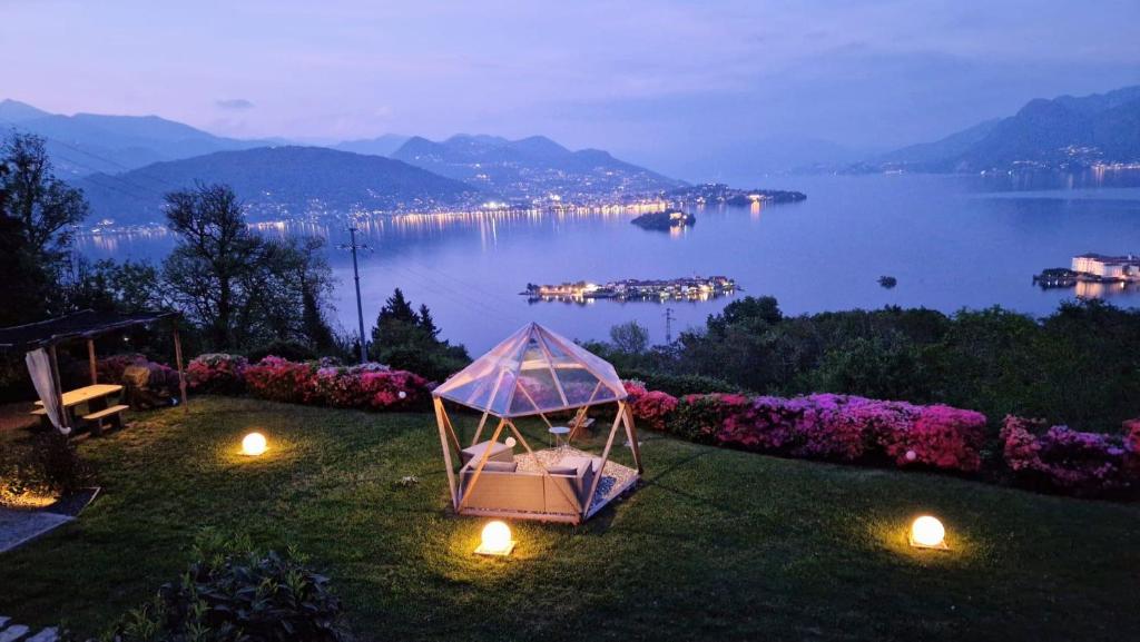 a couple sitting in a gazebo on a lawn with a view at Shambala Home Casa Luna in Someraro