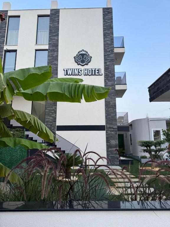 a building with a sign that reads wins hotel at Twins Hotel Vlore in Vlorë